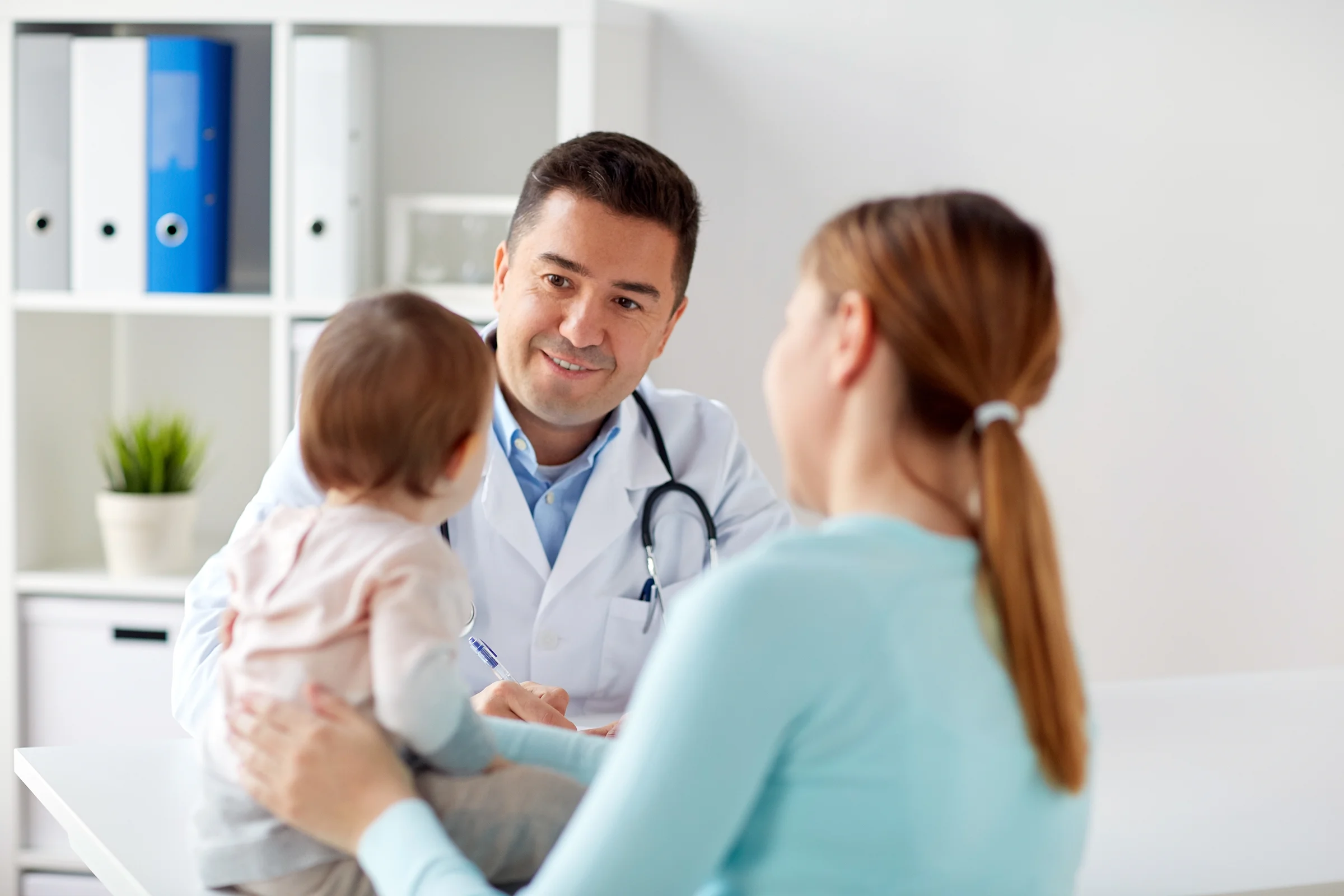 Mother, child and doctor talking